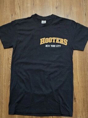 Hooters Black Tee with Gold and White NYC Script